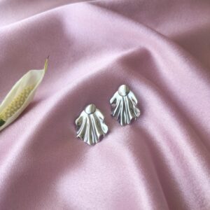 Close-up of silver drape statement earrings with detachable design, made from stainless steel for a tarnish-free shine.