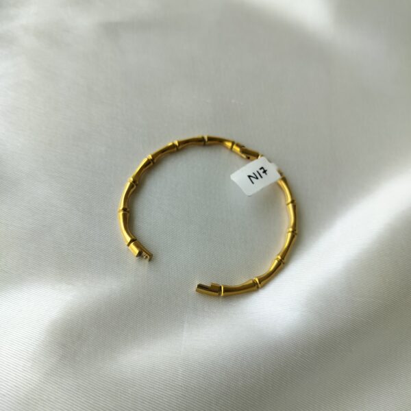 Open hinge mechanism on bamboo gold bracelet