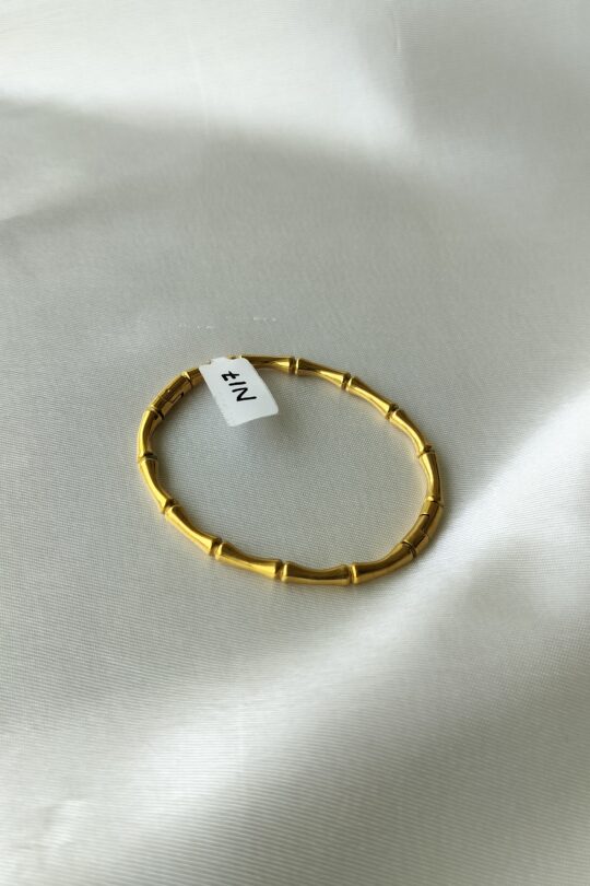 Close-up of bamboo gold bracelet’s gold-plated texture