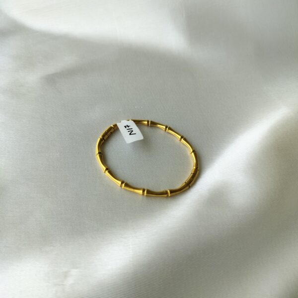 Close-up of bamboo gold bracelet’s gold-plated texture