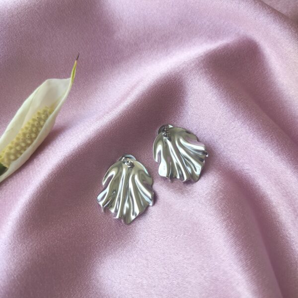 Macro shot of stainless steel silver drape earrings highlighting the tarnish-resistant finish and intricate detailing.