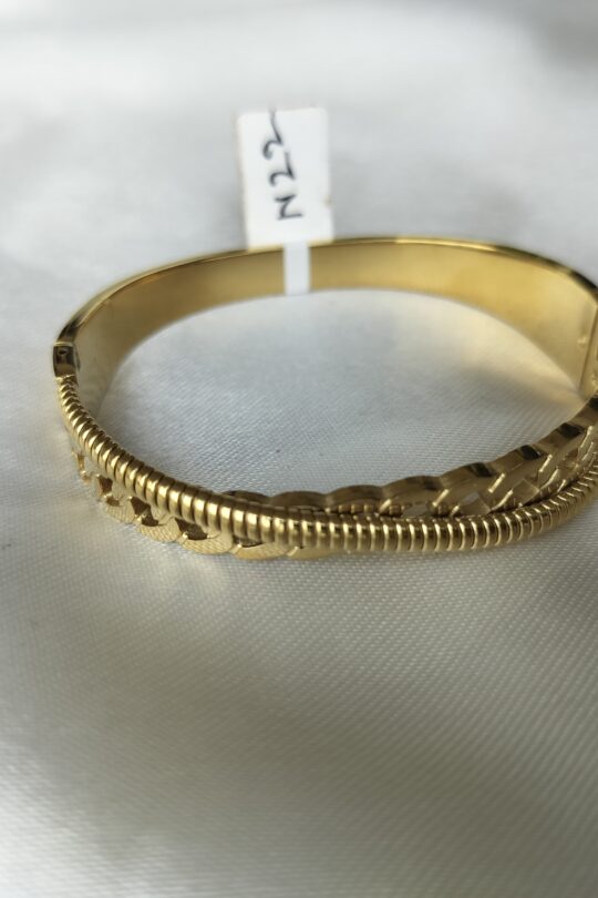 Close-up of intricate filigree style gold bracelet