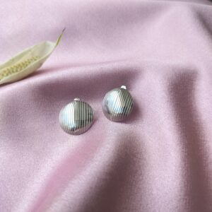 Front view of Lunar Linea Rhodium Studs showing spherical design with vertical lines