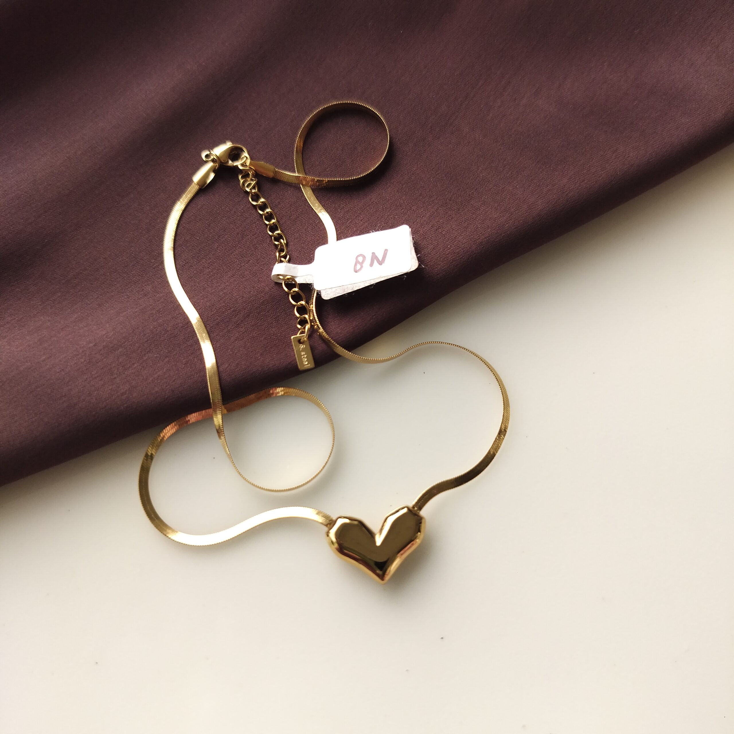 Close up detail of heart pendant attachment on chain