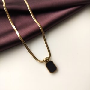 Black Obsidian Curve Necklace front view showing gold curve and black stone.