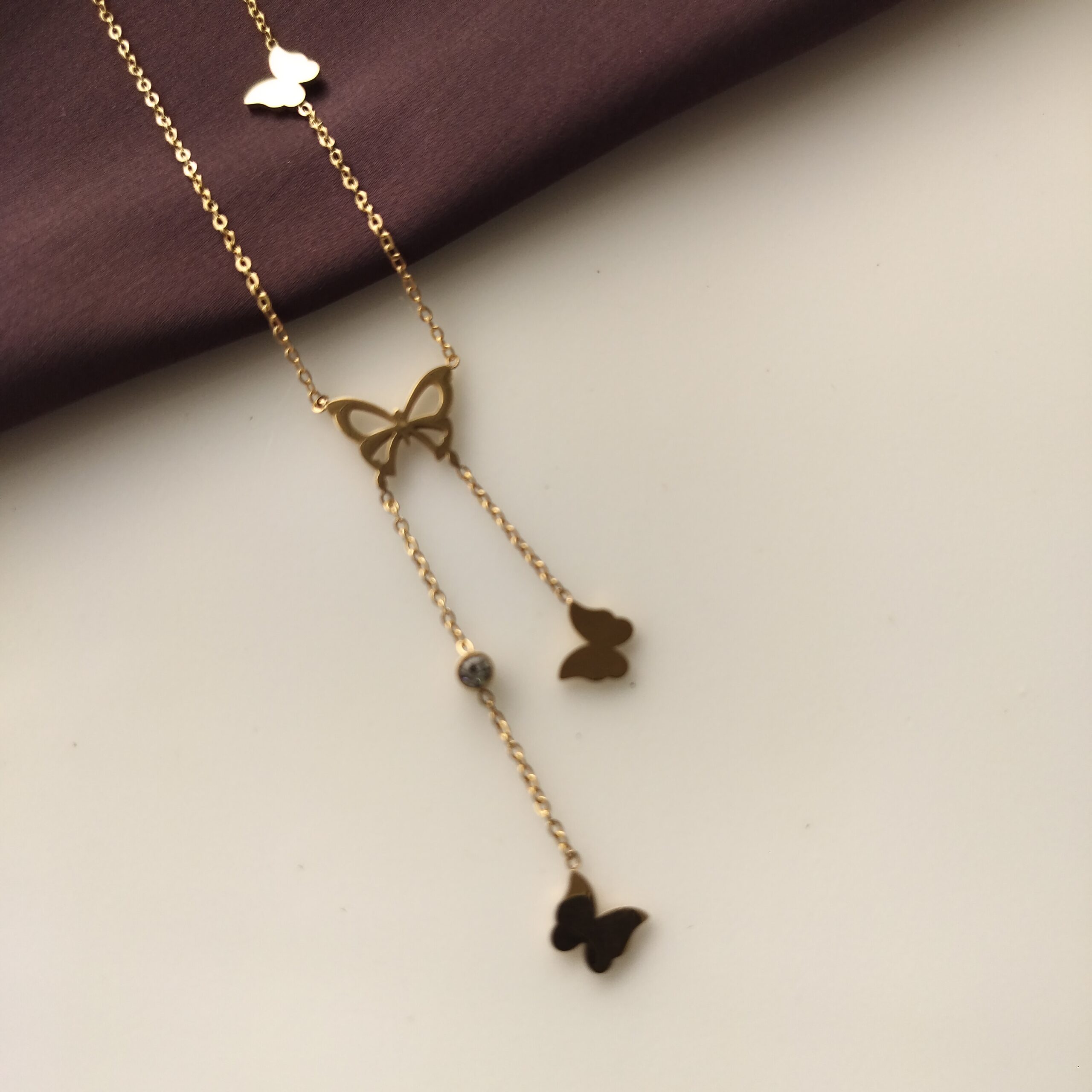 Close up of the gold plated butterfly charms on chain