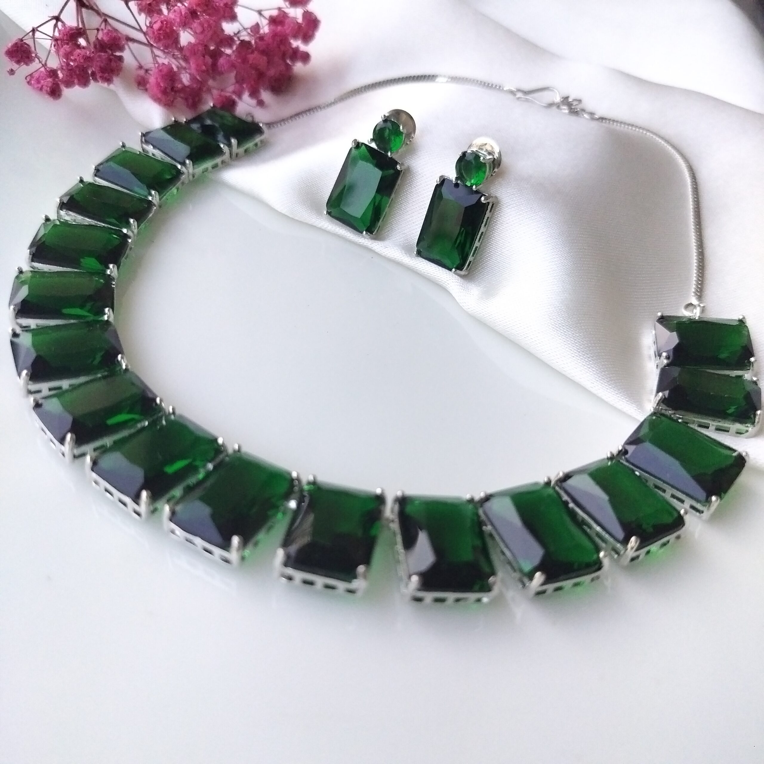 Close up detail of emerald green stones on choker necklace