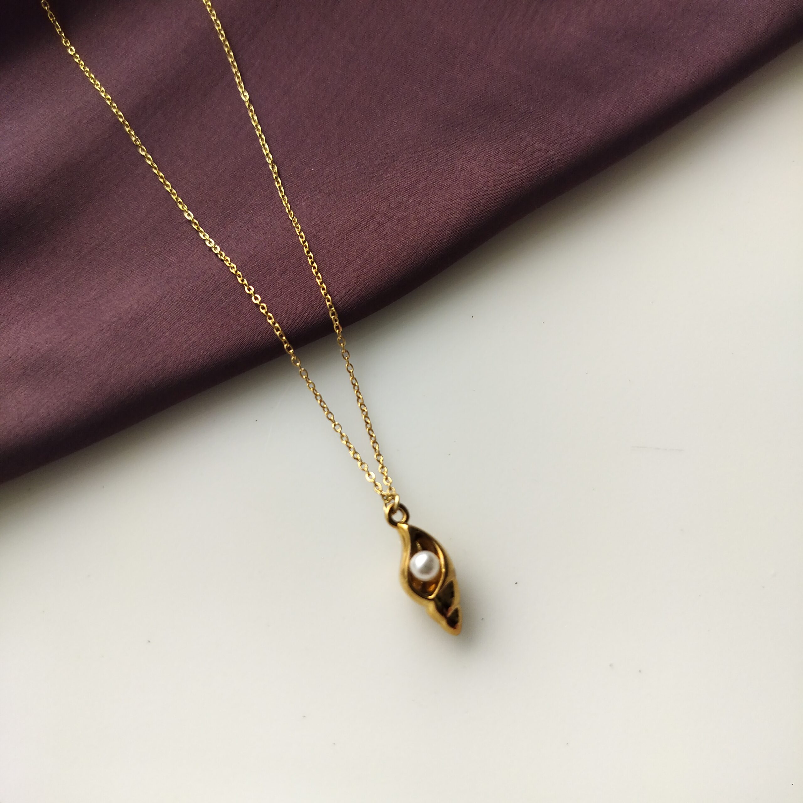 Golden Conch Pearl Pendant Necklace laying flat