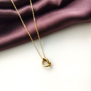 Golden Knot Pendant Necklace front view on display