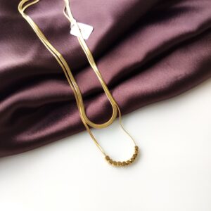Golden Luxe Double Necklace showing two layered gold-plated chains from the front.