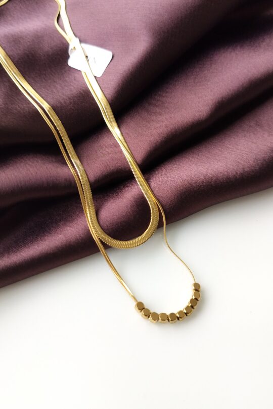 Golden Luxe Double Necklace showing two layered gold-plated chains from the front.