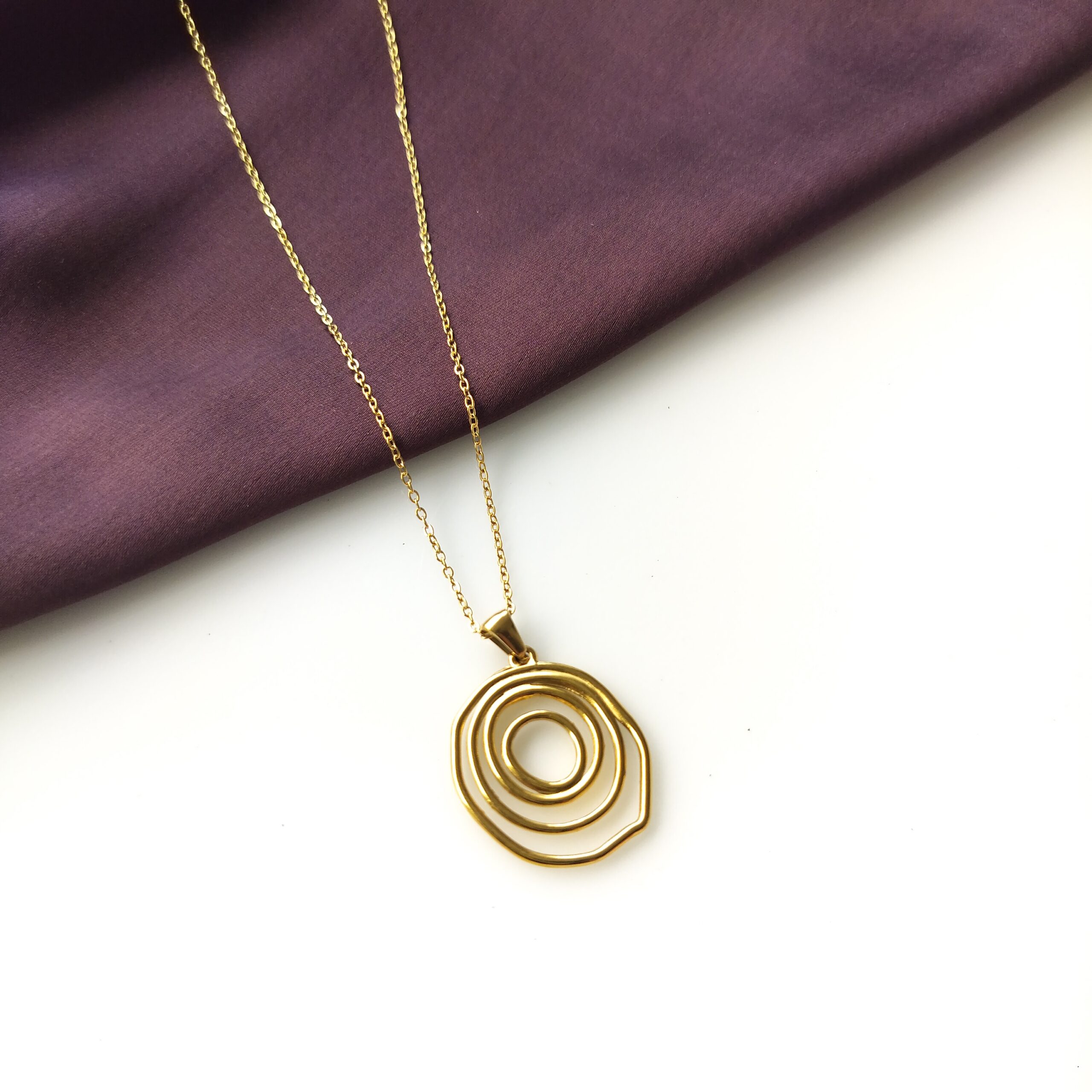 Close up detail of the gold plated spiral pendant's craftsmanship.