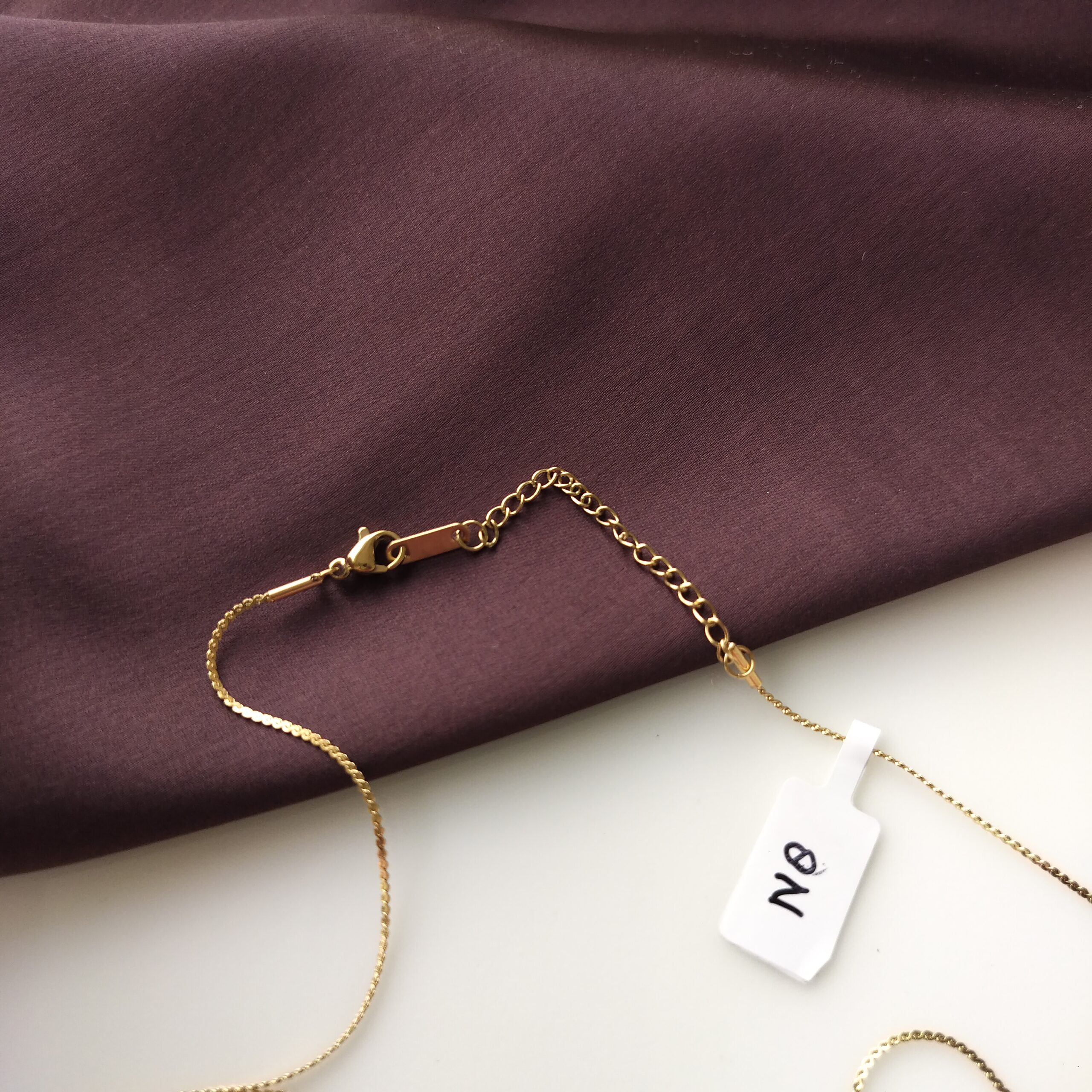 Adjustable extra chain on the Moonlit Teardrop necklace for custom fit.